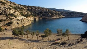 Vathy, a small fjord hugs the spectacular waters of the Libyan Sea|The Libyan Sea in the horizon...|||Paximadia island greets you from afar...||