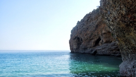 Swim to the caves at the two extremities of the beach!